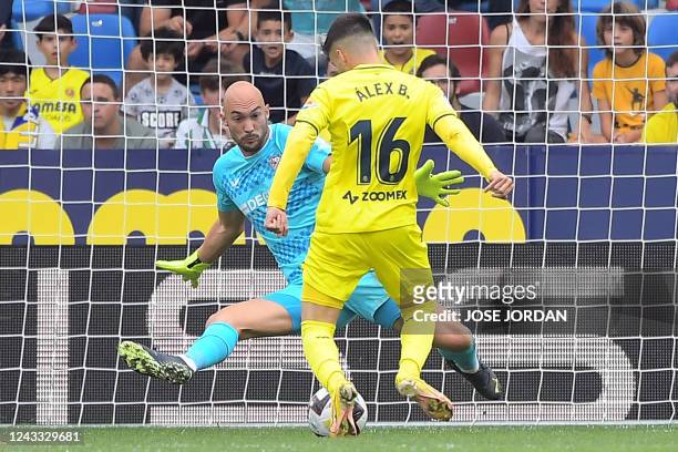 Villarreal's Spanish midfielder Alex Baena scores his team's first goal during the Spanish League football match between Villarreal CF and Sevilla FC...