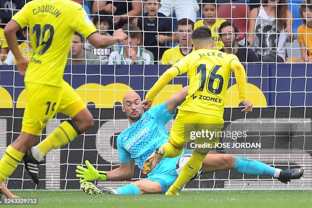 Villarreal's Spanish midfielder Alex Baena scores his team's first goal during the Spanish League football match between Villarreal CF and Sevilla FC...