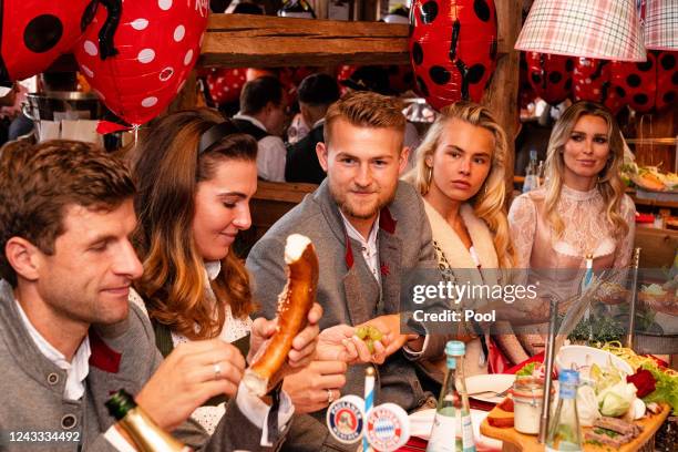 Thomas Mueller of FC Bayern Muenchen, his wife Lisa, Matthijs de Ligt of FC Bayern Muenchen and his partner Annekee Molenaar attend the Oktoberfest...