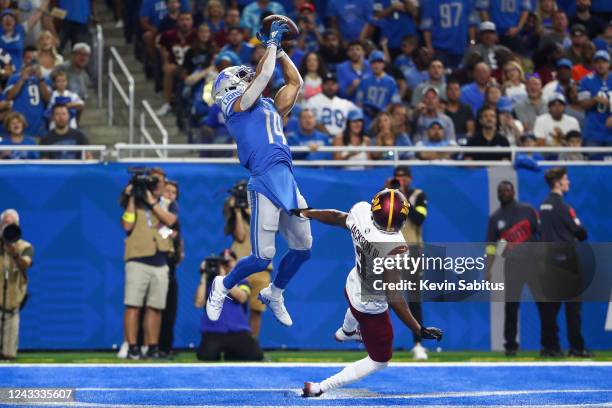 Amon-Ra St. Brown of the Detroit Lions catches a pass over William Jackson III of the Washington Commanders for a touchdown during an NFL football...