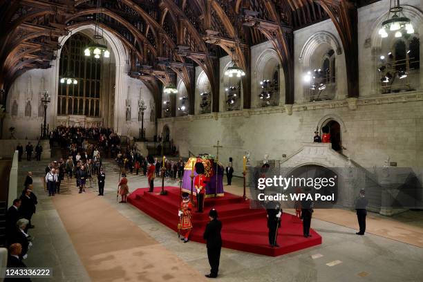 People observe a "National moment of reflection" in honour of the late Queen Elizabeth before they file past the coffin of Queen Elizabeth II during...