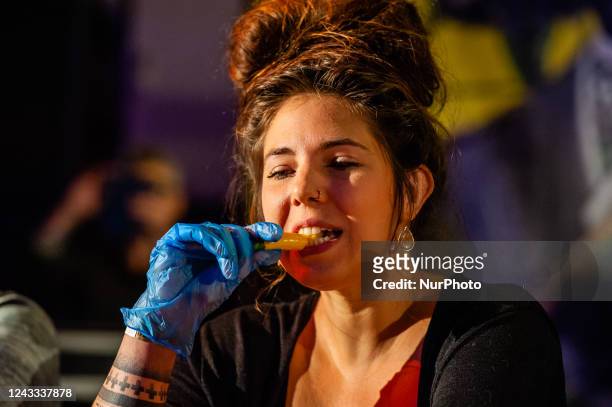Woman is eating a very spicy pepper, during the pepper-eating contest including in the Dutch Chili Festival organized in Eindhoven, on September...