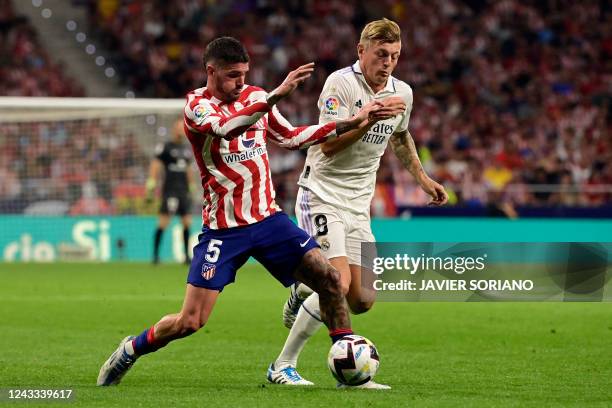 Atletico Madrid's Argentinian midfielder Rodrigo De Paul vies with Real Madrid's German midfielder Toni Kroos during the Spanish League football...