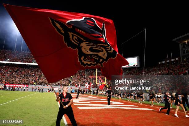 Cheerleader of the NC State Wolfpack waves a flag during their game against the Texas Tech Red Raiders at Carter-Finley Stadium on September 17, 2022...