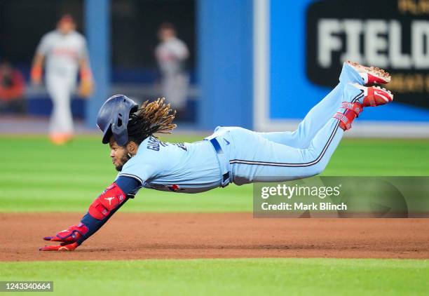 Vladimir Guerrero Jr. #27 of the Toronto Blue Jays dives into second base with a double against the Baltimore Orioles in the fifth inning at the...