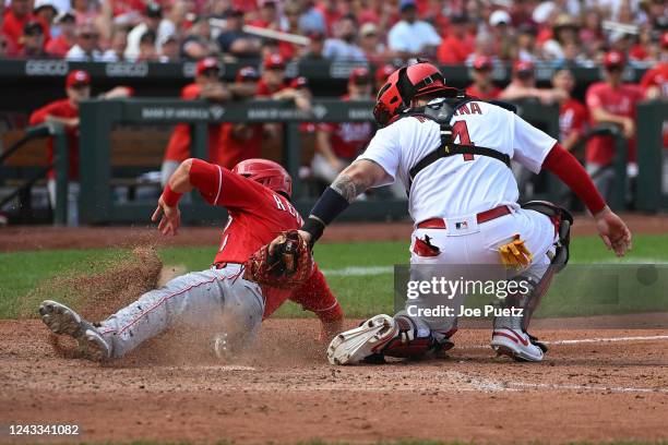 Matt Reynolds of the Cincinnati Reds is tagged out at home plate by Yadier Molina of the St. Louis Cardinals in the ninth inning at Busch Stadium on...