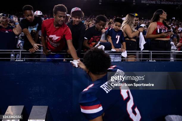 University of Arizona Cornerback Isaiah Rutherford gives his glove to a young fan a College Football game between the University of Arizona Wildcats...