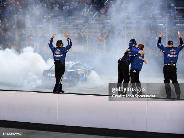 The crew of Chris Buescher celebrates on pit wall after the NASCAR Cup Series Playoff Bass Pro Shops Night Race on September 17 at Bristol Motor...