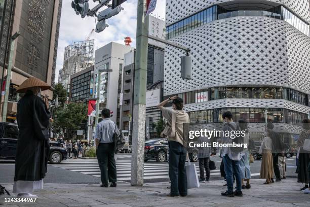Pedestrians wait at an intersection in Tokyo, Japan, on Saturday, Sept. 16, 2022. Japan is scheduled to release consumer price index on Sept. 20....