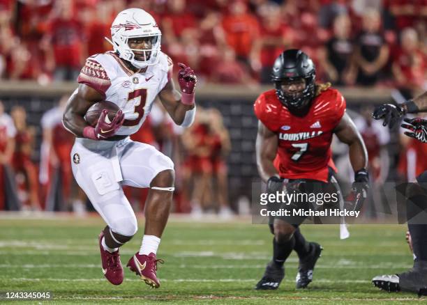 Trey Benson of the Florida State Seminoles runs the ball during the game against the Louisville Cardinals at Cardinal Stadium on September 16, 2022...