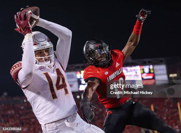 Johnny Wilson of the Florida State Seminoles makes the game winning touchdown catch against Devaughn Mortimer of the Louisville Cardinals during the...