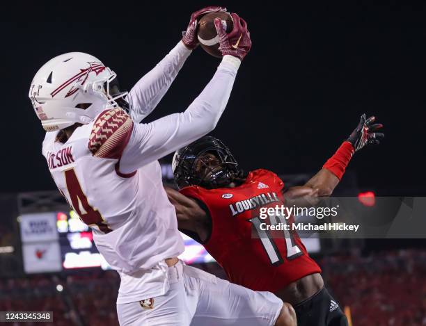 Johnny Wilson of the Florida State Seminoles makes the game winning touchdown catch against Devaughn Mortimer of the Louisville Cardinals during the...
