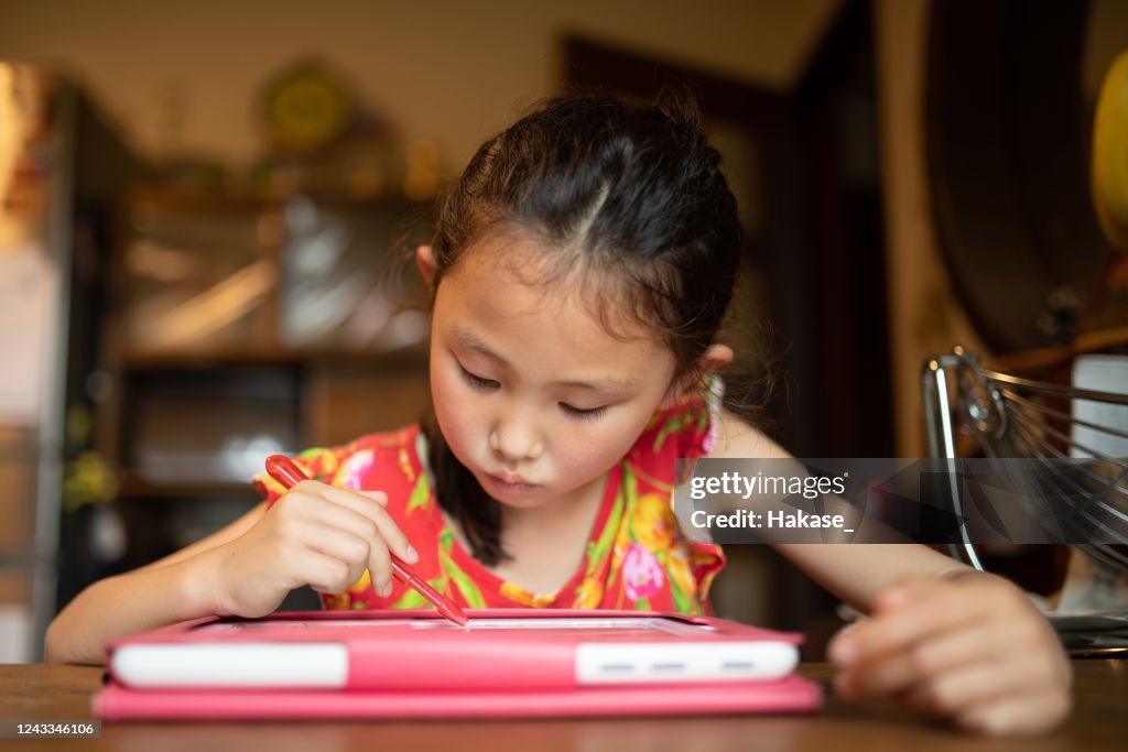 Girl studying on tablet device