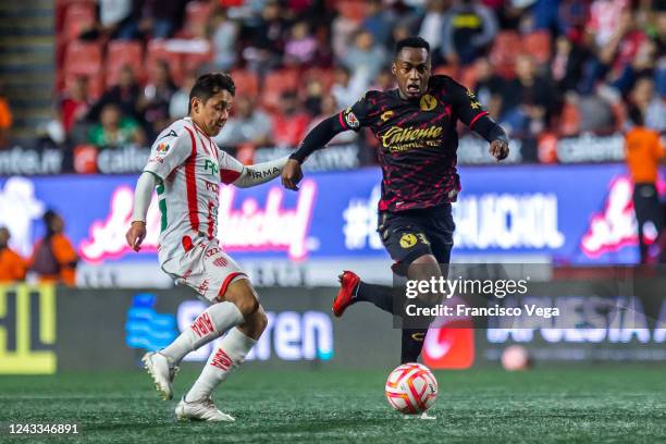 Renato Ibarra of Tijuana fights for the ball with Diego Gómez of Necaxa during the 15th round match between Tijuana and Necaxa as part of the Torneo...