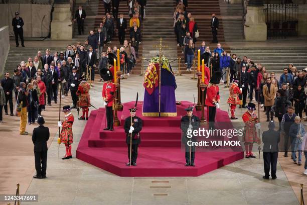 Members of the public pay their respects at 4.57am, as they view the coffin of Queen Elizabeth II, as it Lies in State inside Westminster Hall, at...