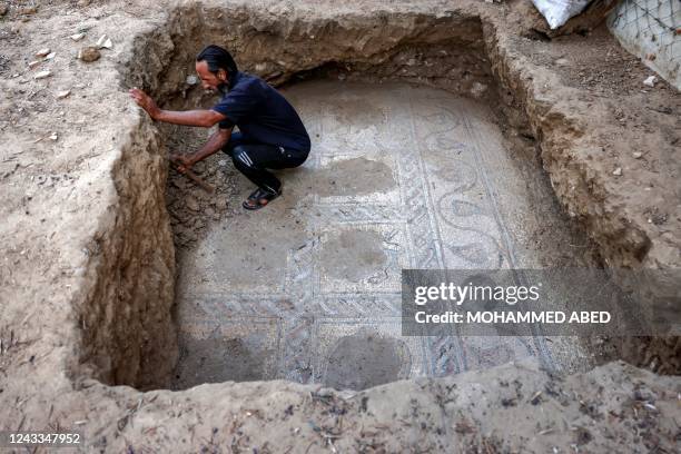 Palestinian farmer Salman al-Nabahin digs to reveal a mosaic floor dating from the fifth to seventh centuries while ploughing his land in Bureij in...