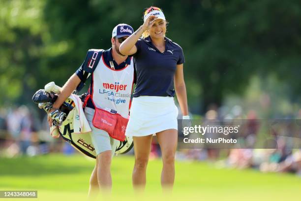 Lexi Thompson of Delray Beach, Florida with her caddie onto the 18th green during the final round of the Meijer LPGA Classic golf tournament at...