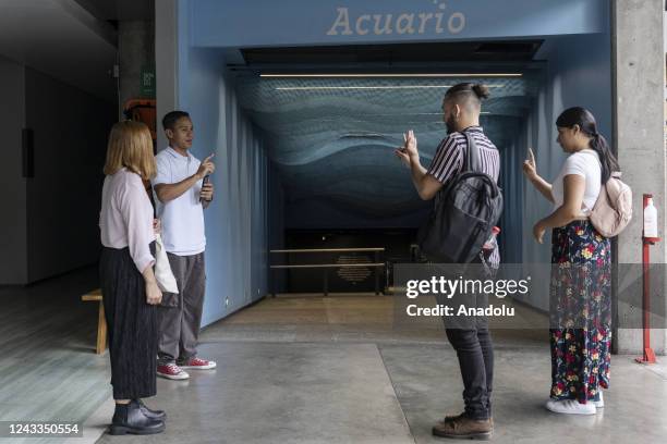 Members of deaf community Sebastian Arenas and Geraldyne Zapata visit the explora park aquarium accompanied by Marian Antonia Soto who works in the...