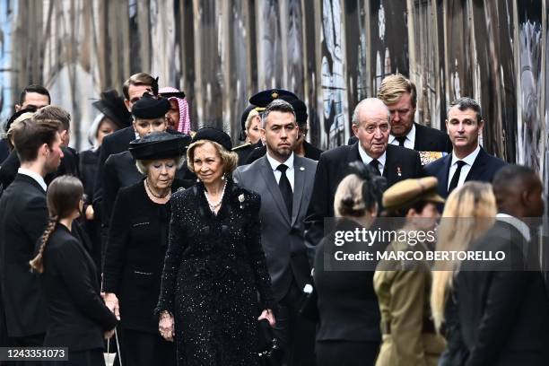 Spain's former King Juan Carlos I and his wife Sofia arrive with Netherlands' Princess Beatrix at Westminster Abbey in London on September 19 for the...