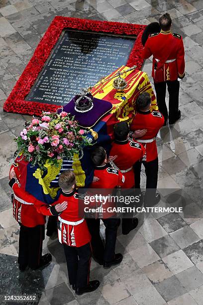 Bearer Party of The Queen's Company, 1st Battalion Grenadier Guards carries the coffin of Queen Elizabeth II, draped in the Royal Standard, into...
