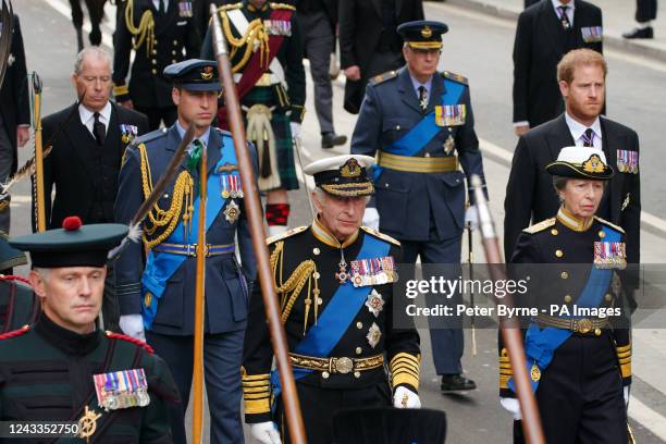 The Prince of Wales, King Charles III, the Princess Royal and the Duke of Sussex following the State Gun Carriage carries the coffin of Queen...