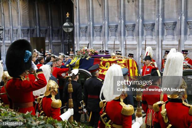 The coffin of Queen Elizabeth II with the Imperial State Crown resting on top i proceeds towards Westminster Abbey on September 19, 2022 in London,...