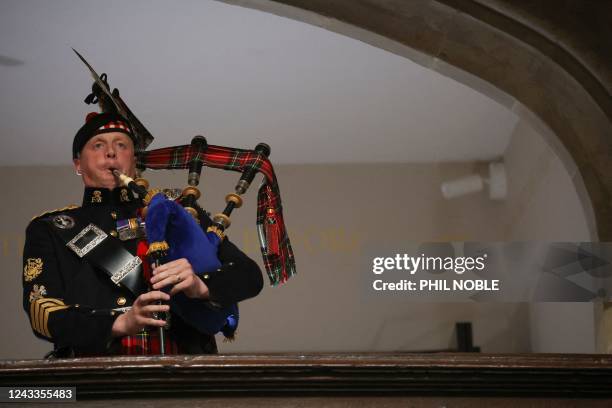 Piper from the Royal Regiment of Scotland plays on the day of the state funeral and burial of Britain's Queen Elizabeth, at Westminster Abbey in...