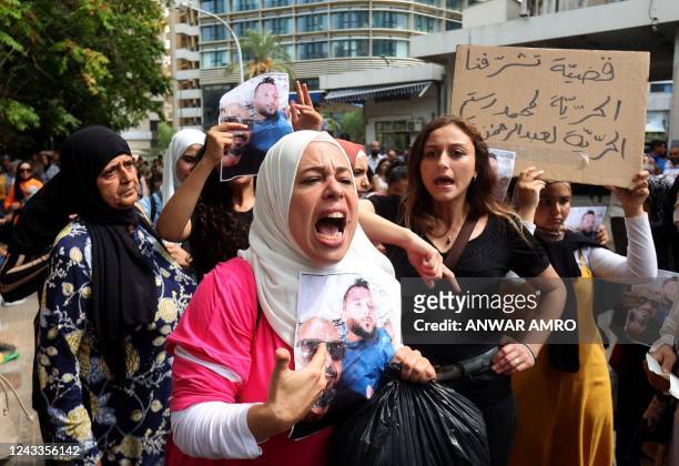Protesters chant slogans as they gather outside the Justice Palace in Lebanon's capital Beirut on September 19 demanding the release of two people...