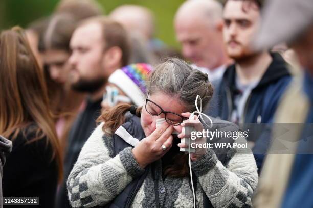 Member of the crowd on The Mall listen during the State Funeral of Queen Elizabeth II at Westminster Abbey on September 19, 2022 in London, England....