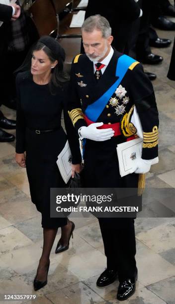 Spain's King Felipe VI and Queen Letizia of Spain walk together out of Westminster Abbey after the state funeral for Britain's Queen Elizabeth II...