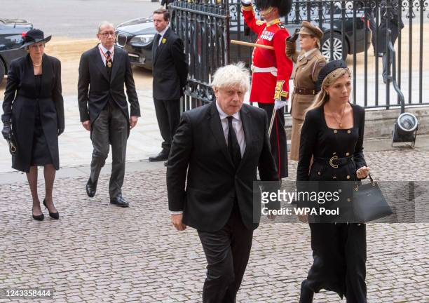 Former British Prime Ministers Boris Johnson and wife Carrie Johnson, and Theresa May and husband Philip May leave after the state funeral of Queen...