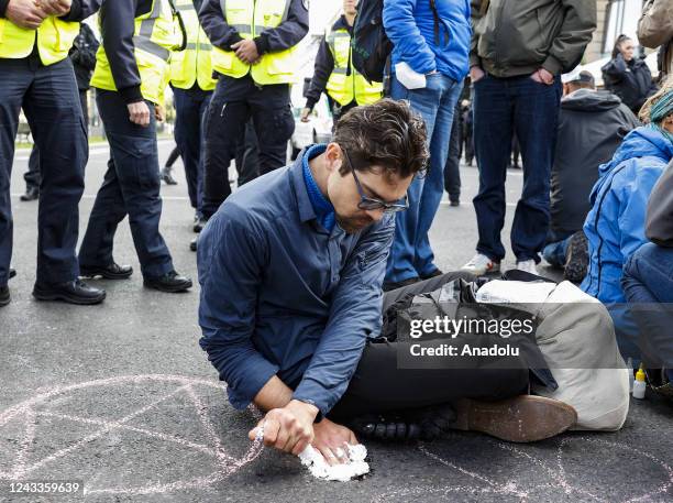 Climate activists glue themselves on ground as they gather to held a protest against the government's climate policy in Berlin, Germany on September...