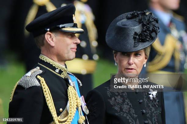 Britain's Sophie, Countess of Wessex and Britain's Prince Edward, Earl of Wessex look at members of the Bearer Party transferring the coffin of Queen...