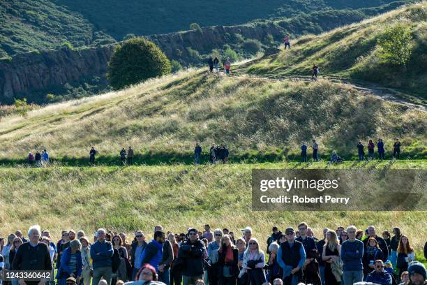 Crowds gather in Holyrood Park to watch the funeral of Queen Elizabeth on a large screen on September 19, 2022 in Edinburgh, United Kingdom....