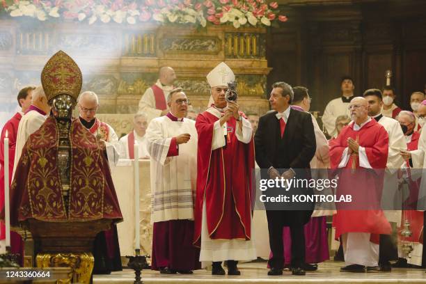 The bishop of Naples, Domenico Battaglia , shows the ampoule with liquefied blood during the ceremony for the solemnity of San Gennaro, in the...