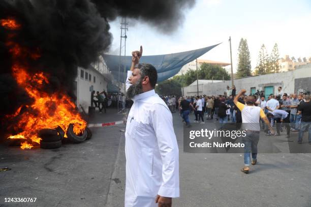 Palestinian protesters burn tires during a demonstration outside the Gaza City headquarters of the United Nations Relief and Works Agency for...