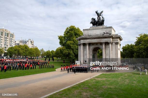 Royal Navy Sailors walk ahead and behind the coffin of Queen Elizabeth II, draped in the Royal Standard, as it arrives on the State Gun Carriage of...