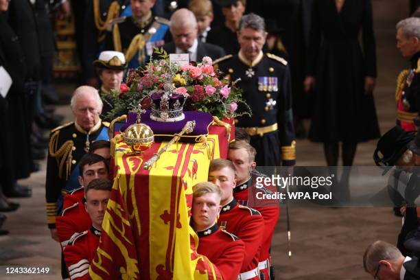 King Charles III follows the coffin of Queen Elizabeth II with the Imperial State Crown resting on top is carried by the Bearer Party into...