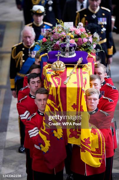 King Charles III and members of the royal family follow behind the coffin of Queen Elizabeth II, draped in the Royal Standard with the Imperial State...