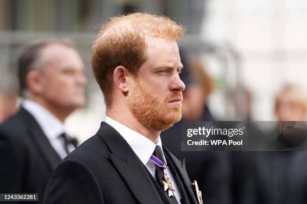 Prince Harry, Duke of Sussex follows the coffin of Queen Elizabeth II as it leaves Westminster Abbey during the state funeral of Queen Elizabeth II...