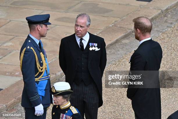 Britain's Prince William, Prince of Wales and Britain's Prince Harry, Duke of Sussex talk with Britain's Earl of Snowdon next to Britain's Princess...