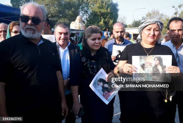 Iraqi and Iranian Kurds, residing in northern Iraq, march near a park in the Iraqi Kurdish city of Sulaimaniya on September 19 against the death of...