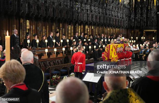 The Bearer Party take the coffin of Queen Elizabeth II, from into St George's Chapel inside Windsor Castle on September 19 for the Committal Service...