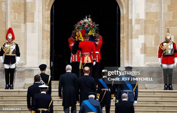The Bearer Party take the coffin of Queen Elizabeth II, from the State Hearse, into St George's Chapel inside Windsor Castle on September 19 for the...