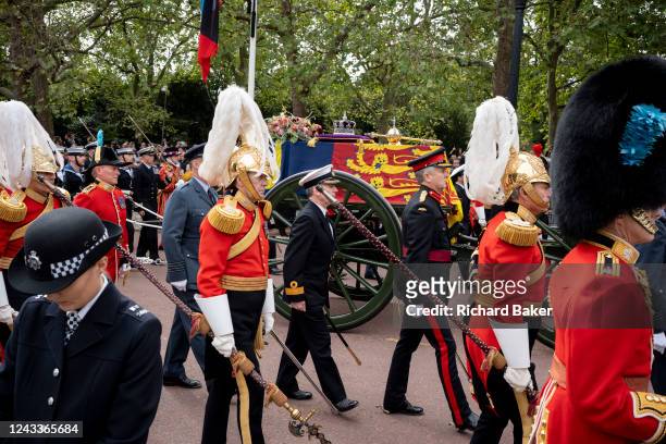 Following the death of Queen Elizabeth II at the age of 96, her coffin with sceptre, crown and orb resting on the top, is draped with the Royal...