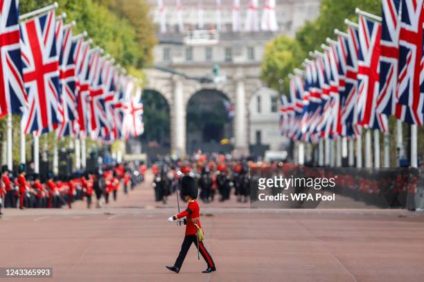 King's guard crosses The Mall during the State Funeral of Queen Elizabeth II on September 19, 2022 in London, England. Elizabeth Alexandra Mary...