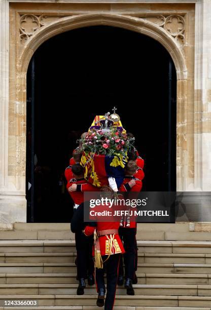 Pall bearers carry the coffin of Queen Elizabeth II with the Imperial State Crown resting on top into St. George's Chapel at Windsor Castle on...