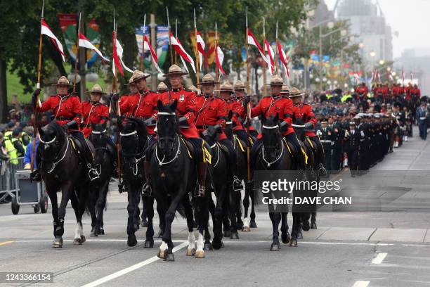 Royal Canadian Mounted Police Musical Ride lead a military parade through downtown Ottawa, Ontario, Canada, on September 19 during a memorial service...