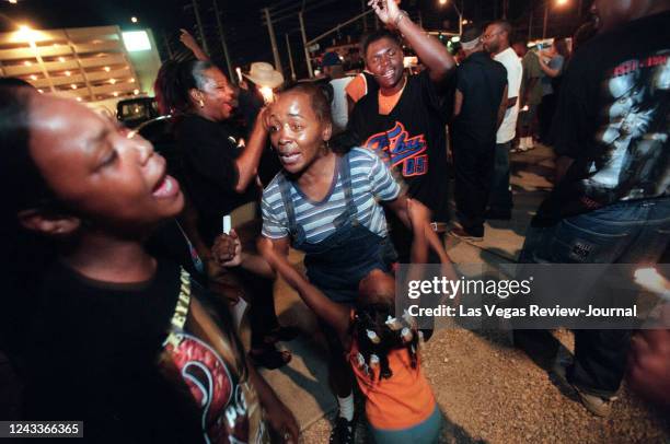 Fans dance during a candlelight vigil in 1998 on the second anniversary of the death of Tupac Shakur. About one hundred people attended the gathering...