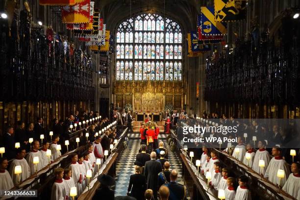 The coffin of Queen Elizabeth II is carried by Pall bearers from the Queen's Company, 1st Battalion Grenadier Guards during the Committal Service for...